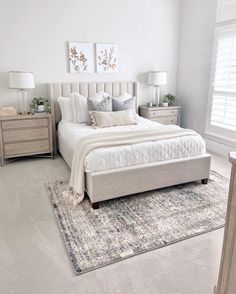 a bedroom with a large bed and two nightstands on either side of the bed