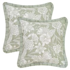 two green pillows with white flowers on them