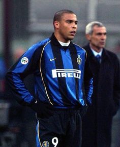 two men standing next to each other on a soccer field