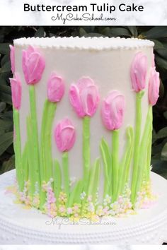 a white cake with pink and green flowers on it