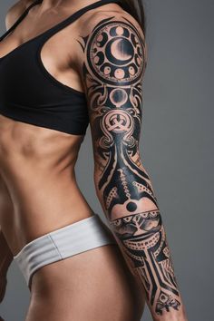 a woman with a tattoo on her arm and chest is posing for the camera,