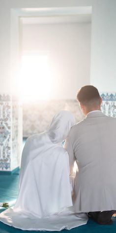 a man and woman are sitting on the floor