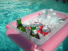 an inflatable pool float with drinks and water bottles on it is floating in the blue water