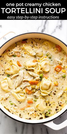 a pot filled with tortellini soup on top of a marble counter