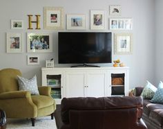 a living room filled with furniture and pictures on the wall