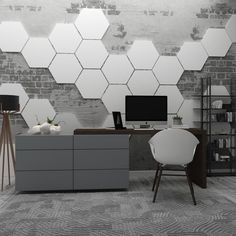 an office with two computer desks and a chair in front of a brick wall that has hexagonal tiles on it