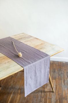 a wooden table with a purple cloth on it