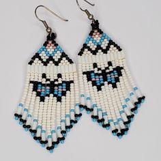 a pair of beaded earrings with black, white and blue beads