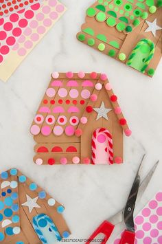 paper plates and crafting supplies are laid out on the table to make gingerbread houses