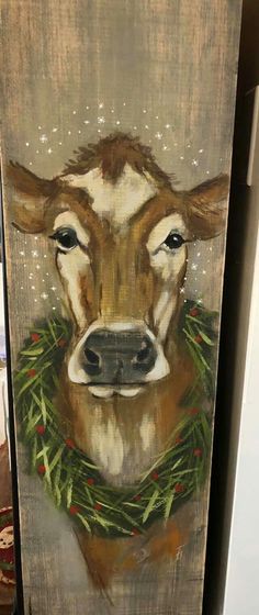 a painting of a cow wearing a wreath