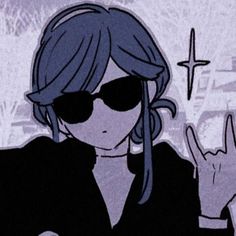 a woman wearing sunglasses making the peace sign