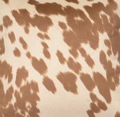 a brown and white spotted animal print pillow