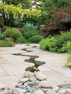 a garden with rocks and water in it