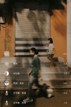 two people walking down the street in front of a building with shutters on it