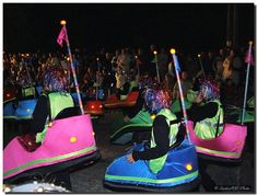 some people are riding bumper cars in the dark