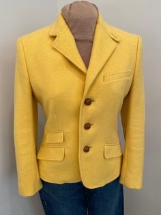 Stunning Ralph Lauren wool three leather button closure, fully lined blazer jacket in sunflower yellow. Beautifully detailed with faux front pockets and leather elbow patches and braided leather buttons. Perfect for autumn and spring wear.  This is in excellent condition and tagged a size 8. See laying flat measurements  Shoulder:17" Bust:38" Waist:34" Length:23" Sleeve:22" Classic Yellow Blazer For Business, Fitted Yellow Blazer For Business, Fall Yellow Blazer With Button Closure, Yellow Blazer With Button Closure For Fall, Yellow Notch Lapel Outerwear For Fall, Classic Single-breasted Yellow Blazer, Yellow Notch Lapel Blazer For Fall, Yellow Single-breasted Notch Lapel Blazer, Fitted Yellow Winter Blazer