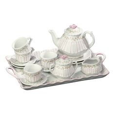 a tea set with cups and saucers on a tray