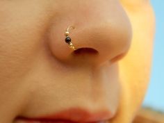 a close up view of a nose with a nose ring on it's side