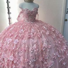 a pink ball gown with flowers on it