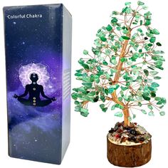 a small tree sitting next to a box with the image of a person on it