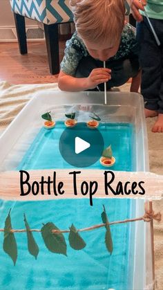 a young boy is playing with a bottle top race in the water and holding a toothpick