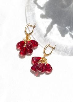 Gold Plated Pomegranate Dangle Earrings - Murano Lampwork Bead, Minimalist Seed Jewelry, Elegant Fruit Inspired Accessories Check out our jewelry selection for unique and custom handmade items from CharmLuckyByPelin. PRODUCT FEATURES; → Gold plated brass, murano glass beaded earrings. → Earring color: Gold, Red, Pink → It's dainty and it can be worn daily. 🎁 Our gift of a luck bracelet with evil eye beads is shipped with your order. ✿ Find more to here: https://www.etsy.com/shop/CharmLuckyByPel Briolette Dangling Beads Earrings Gift, Gift Briolette Earrings With Dangling Beads, Seed Jewelry, Fruit Jewelry, Shiny Objects, Gothic Earrings, Fruit Earrings, Jewelry Elegant, Nose Jewelry