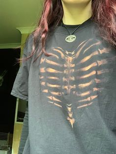 a woman with long hair wearing a skeleton shirt