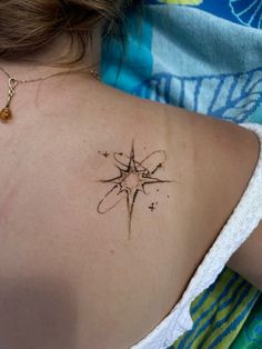 a woman with a compass tattoo on her back