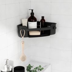 a bathroom shelf with soap, toothbrushes and lotion bottles hanging from it