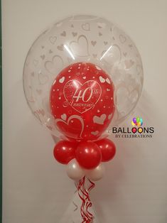 the balloon is in the shape of a heart and has an anniversary number on it