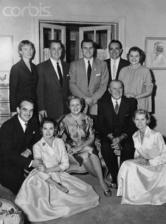 black and white photograph of people in formal wear posing for a group photo, possibly from the 1950's