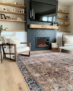 a living room filled with furniture and a fire place in the middle of the room