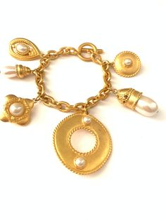 "Vintage Byzantine Revival Moghul Pearl Charm Medallion Bracelet // Chunky Gold Plated Charm Bracelet Gorgeous vintage gold plated charm bracelet. It has a smooth satin matte plated finish with 6 large chunky charms. The largest charm measures 1 5/8\", the little coin charm with faux pearl measures 7/8\" and the smallest charm, the little pearl measures 3/8\" x 7/8\". The bracelet is new old stock vintage from the 1980s so aside from some minor wear from being in storage (small dings/light scuff Chunky Gold Bracelet, Puffy Heart Charms, Storage Small, Victorian Gold, Small Charms, Large Jewelry, Bracelet Vintage, Pearl Charms, Short Necklace