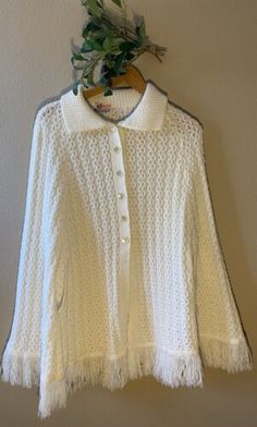 Vintage Americana Knit Button-Up Shawl Poncho Sweater Ivory Fringe Collar Granny  | eBay White Long Sleeve Cape For Spring, White Long Sleeve Spring Cape, White Fall Poncho, White Long Sleeve Poncho For Fall, White Knit Sweater With Buttons, White Long Sleeve Cape For Fall, Cream Long Sleeve Poncho For Winter, Long Sleeve Cream Poncho For Winter, Cozy White Winter Cape