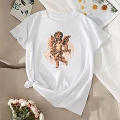 Enter a world of elegance and mysticism with our "Vintage Cherubino T-Shirt". This unique design combines the charm of classic cherubs with a modern twist of abstract lines, creating a unique and charming t-shirt. Made of soft and comfortable cotton, it is perfect for those who love to stand out with style. Wear this t-shirt and bring a little art and magic into your daily life. Vintage Cherub, Angel Gifts, Fashion Tshirt, Tshirt Fashion, Design Tshirt, Abstract Lines, Unisex Tshirt, Vintage Tshirts, T Shirt Design