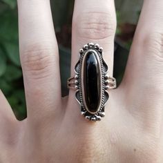 "This is a gorgeous Black Onyx and Sterling Silver Ring that has a long oval shaped Black Onyx cabochon. The raised Onyx cabochon has been set in an ornate Sterling Silver bezel that is slightly rounded on the back making it super comfortable sitting against the finger. The rounding at the back of the bezel allows for the ring to fit perfectly against the shape of your finger. The ring has been slightly oxidized to show the details in the setting and then polished to a high sheen to bring out th Vintage Black Oval Cabochon Jewelry, Oval Onyx Black Jewelry, Black Onyx Oval Jewelry, Oval Black Onyx Jewelry, Black Sterling Silver Jewelry With Oval Cabochon, Black Oval Cabochon Sterling Silver Jewelry, Oval Onyx Cabochon Ring, Oval Cabochon Onyx Ring, Black Oval Cabochon Jewelry