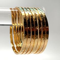 Gold bangles come in a wide array of designs, making them suitable for various occasions. Whether it’s a simple, minimalist band for everyday wear or an ornate, gem-studded piece for a special event, there’s a gold bangle to suit every style and need. Princess Diamond Earrings, Solid Gold Bangle, Stacking Bangles, Hammered Bangles, Flat Wire, Nyc Studio, روتين العناية بالبشرة, Silver Flats, Gold Bangles Design