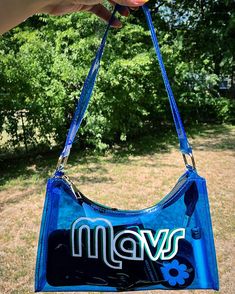 Transparent blue handbag with white and green Mavs logo. Each bag is hand made to order. 9.5 x 6.25 x 2.5 inches Mavs Logo, Clear Stadium Bag, Blue Handbag, Stadium Bag, Blue Handbags, Dallas Mavericks, Purses And Handbags, Dallas, Shoulder Bags