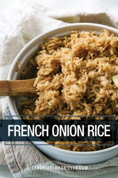 french onion rice in a white bowl with a wooden spoon and napkin next to it