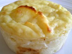 a close up of a pastry on a white plate with food in the middle,