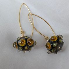 Introducing our stunning fused glass earrings, carefully crafted from brown and beige glass beads using an intricate lampwork technique. Each pair is a work of art, radiating elegance and charm. The earrings of these earrings are made of 925 sterling silver with 18k gold plated and will add sophistication to any ensemble. Enhance your look with the timeless beauty of our fused glass jewelry. Indulge yourself in handmade craftsmanship and elegance with our lampwork glass earrings. Shop now and ad Brown Czech Glass Bead Earrings, Handmade Bronze Czech Glass Earrings, Brown Czech Glass Teardrop Earrings, Unique Glass Jewelry With Matching Earrings, Artisan Gold Earrings With Czech Glass, Amber Czech Glass Drop Earrings, Elegant Recycled Glass Earrings With Ear Wire, Brown Czech Glass Dangle Earrings, Handmade Amber Earrings In Czech Glass