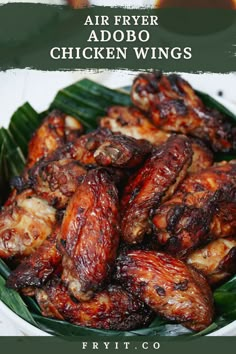 chicken wings on a plate with the words, air fryer adobo wings