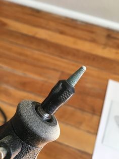 a close up of a metal object on a wooden floor