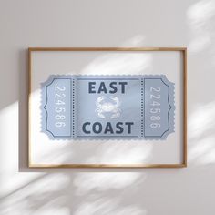 an east coast ticket hanging on the wall in front of a white wall with shadow