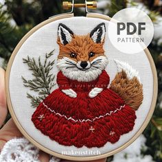 a hand embroidered fox in a red dress