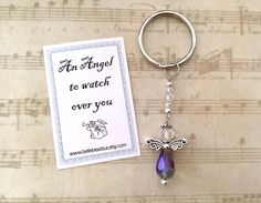 a keychain with a card attached to it that says, far angel to watch over you