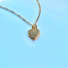 This listing is for a beautiful 14k gold filled Cubic Zirconia heart necklace.  An exquisite piece that goes well alone or paired with other pieces.   Description:  Materials: 14K Gold Filled Chain, 14K Gold Filled Pendant Pendant size: 11.7mm x 7.8mm Pictured is the necklace with length of 16 inches. For shipping details / gift box option, please see FAQs section or feel free to contact me with any questions :) Thank you for visiting! Heart Pendant Charm Necklace With Cubic Zirconia For Gift, Gift Cubic Zirconia Heart Pendant Charm Necklace, Delicate Gold Charm Necklace With Diamond Accents, Delicate Chain Cubic Zirconia Charm Necklace For Anniversary, Dainty Gold Diamond Charm Necklaces, Dainty Gold Charm Necklace With Diamond Accents, Yellow Gold Necklaces With Heart Pendant Cubic Zirconia, Dainty Diamond Charm Necklace In Gold, Yellow Gold Necklaces With Cubic Zirconia Heart Pendant