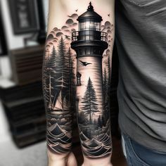 a man's arm with a lighthouse tattoo on it and trees in the background