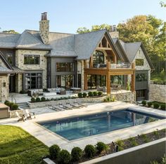 a large house with a swimming pool in the front yard and an outdoor dining area