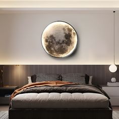 a large bed sitting under a clock mounted to the side of a wall in a bedroom